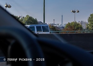 A peak of the Eiffel Tower in the distance